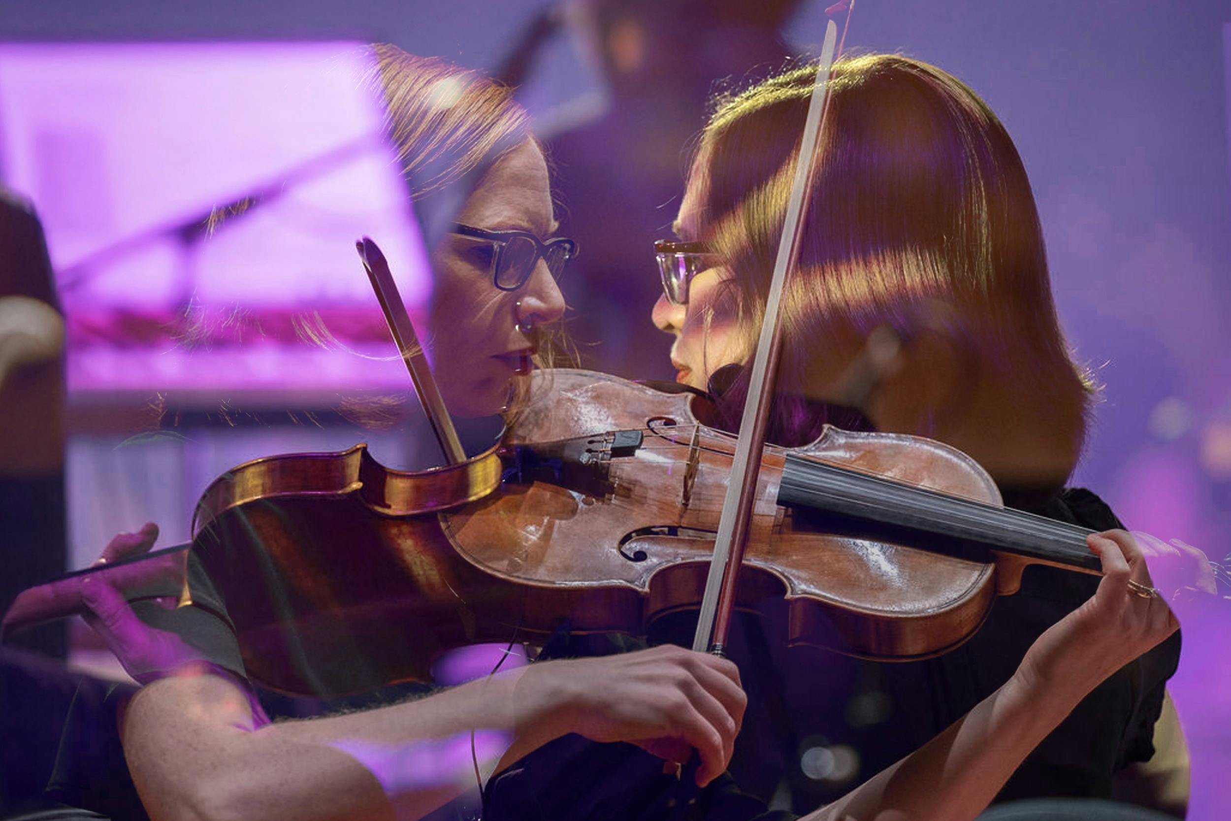 A double exposure of a violin player from both a front on and back on, the image has a purple hue