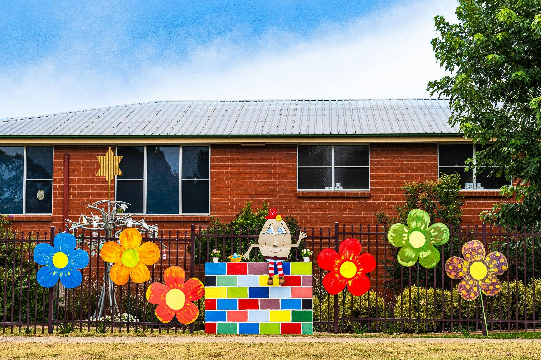 Colourful Humpty Dumpty artwork on fence