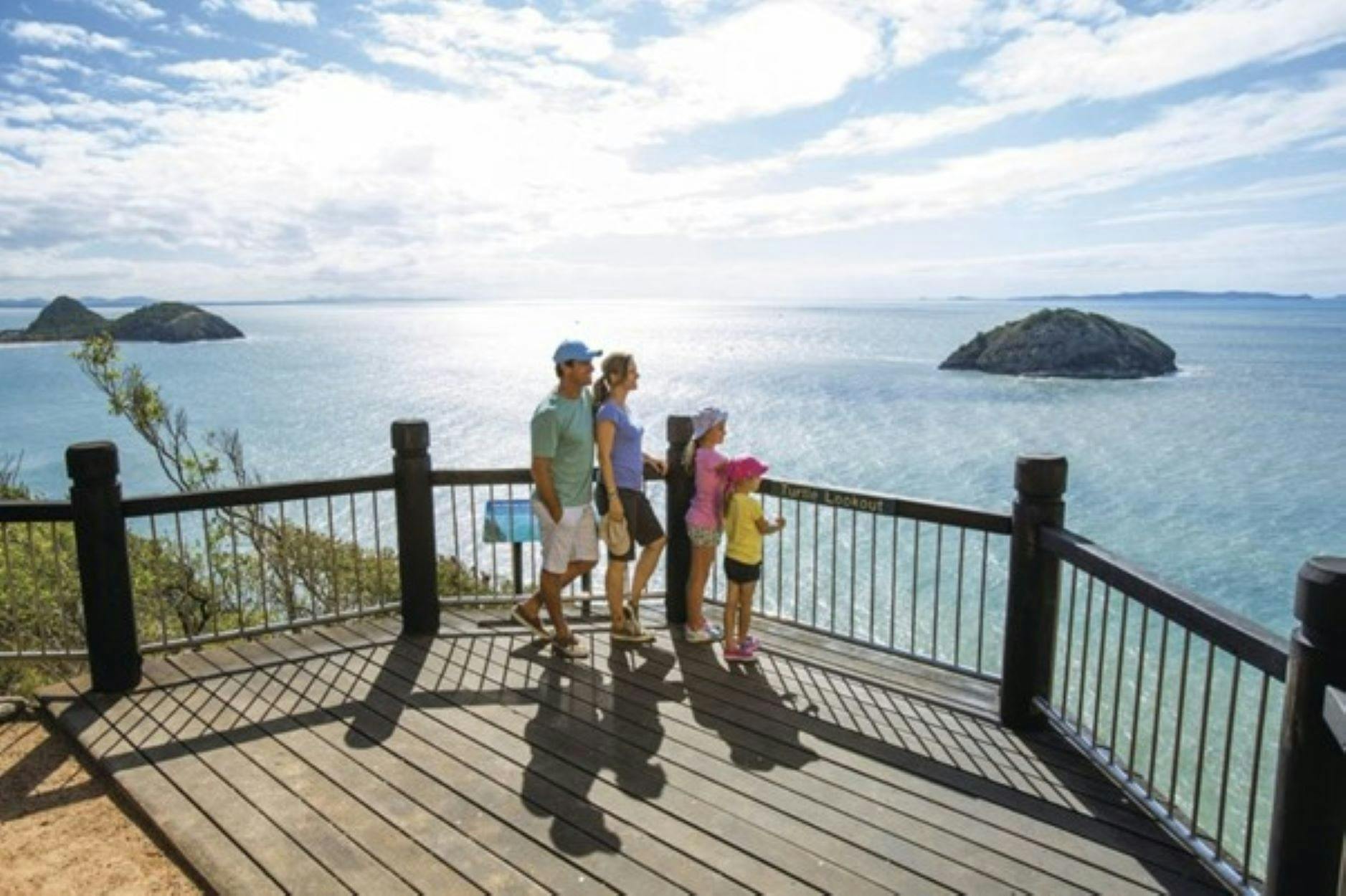 Man, Lady and two girls enjoying the view overlooking the water at Yeppoon