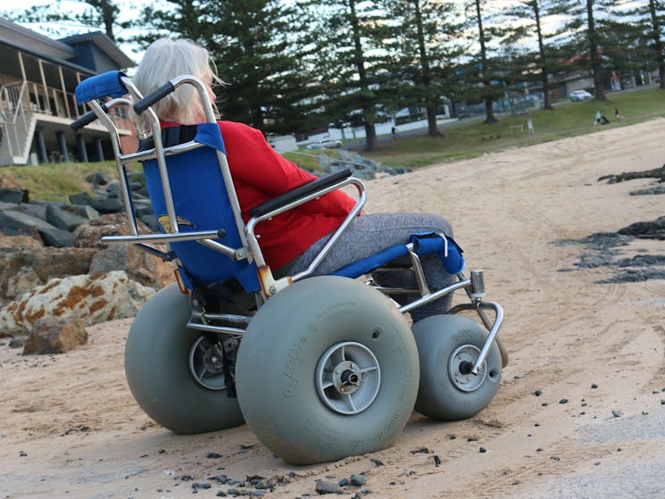 Woman in beach wheelchair on beach