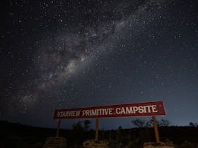 Starview Campsite entry sign at night showing the milky way