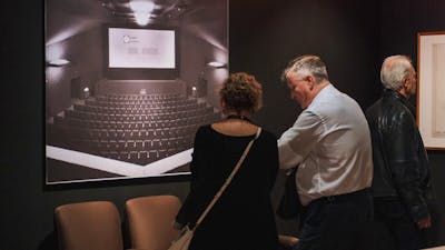 People exploring the Taglietti exhibition looking at Center Cinema installations