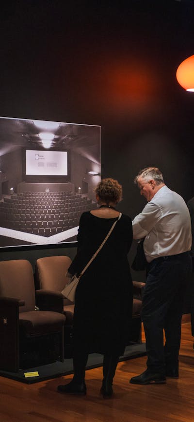 People exploring the Taglietti exhibition looking at Center Cinema installations