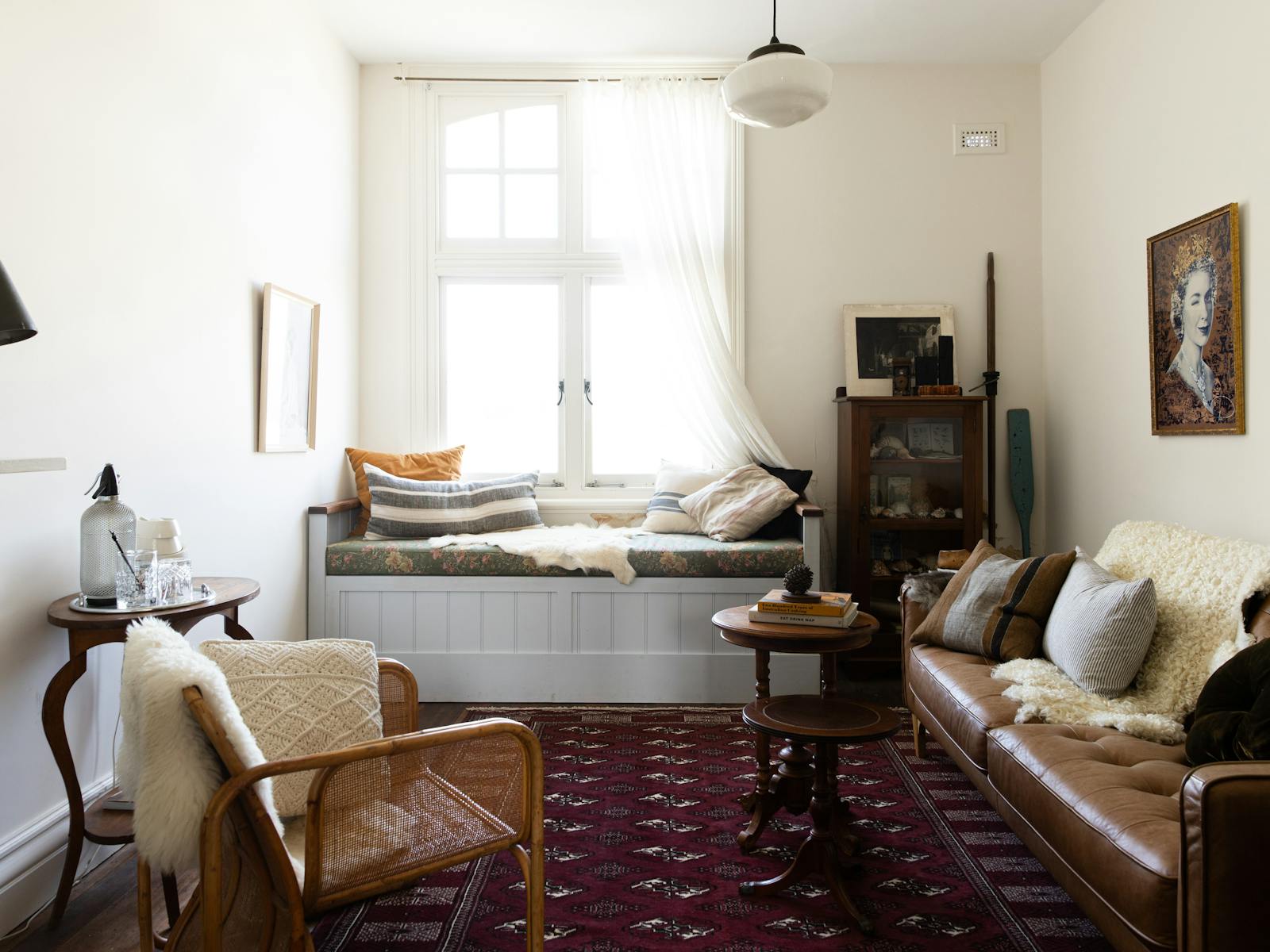 A cosy loungeroom with a window seat covered in linen cusions