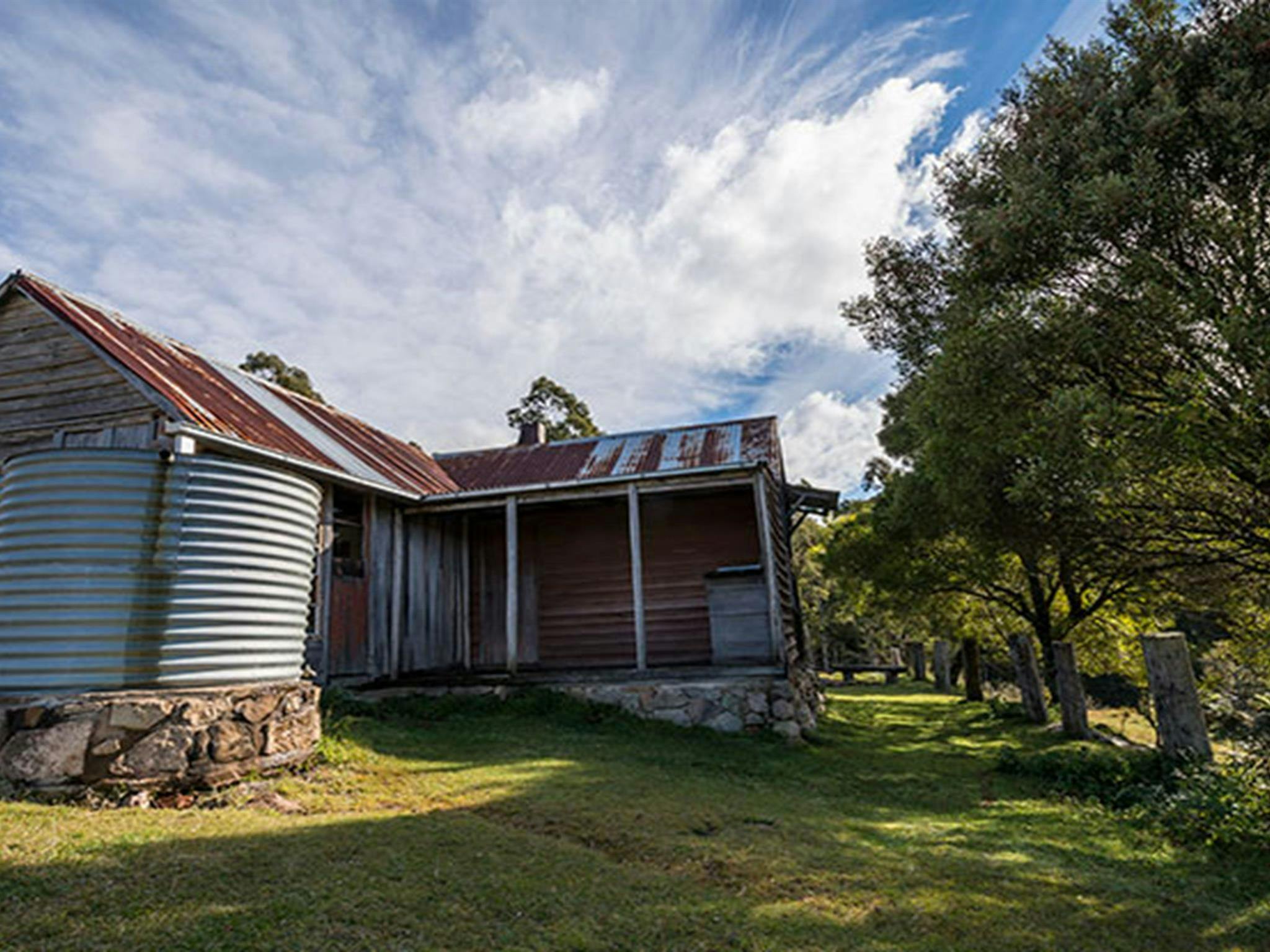 Close up of Alexanders Hut with water tank in the foreground. Photo: John Spencer/OEH