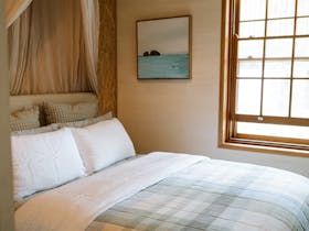 Queen bed, linen duvet, Australia wool underlays, local artwork