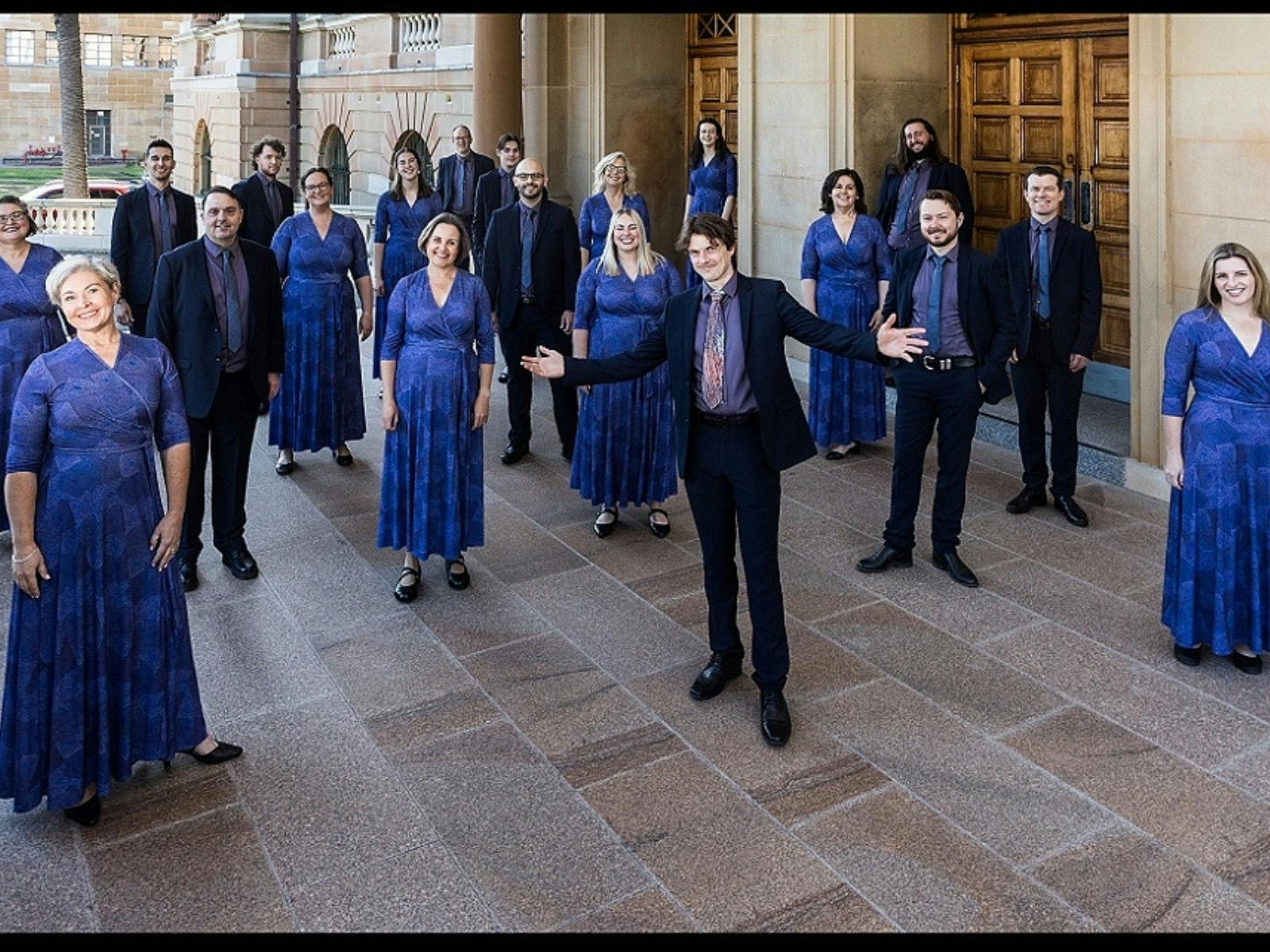 men and women standing in front of a church