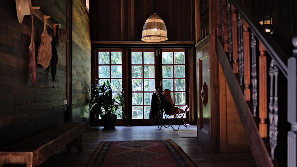 Cabin with high ceilings and french doors overlooking rainforest gardents