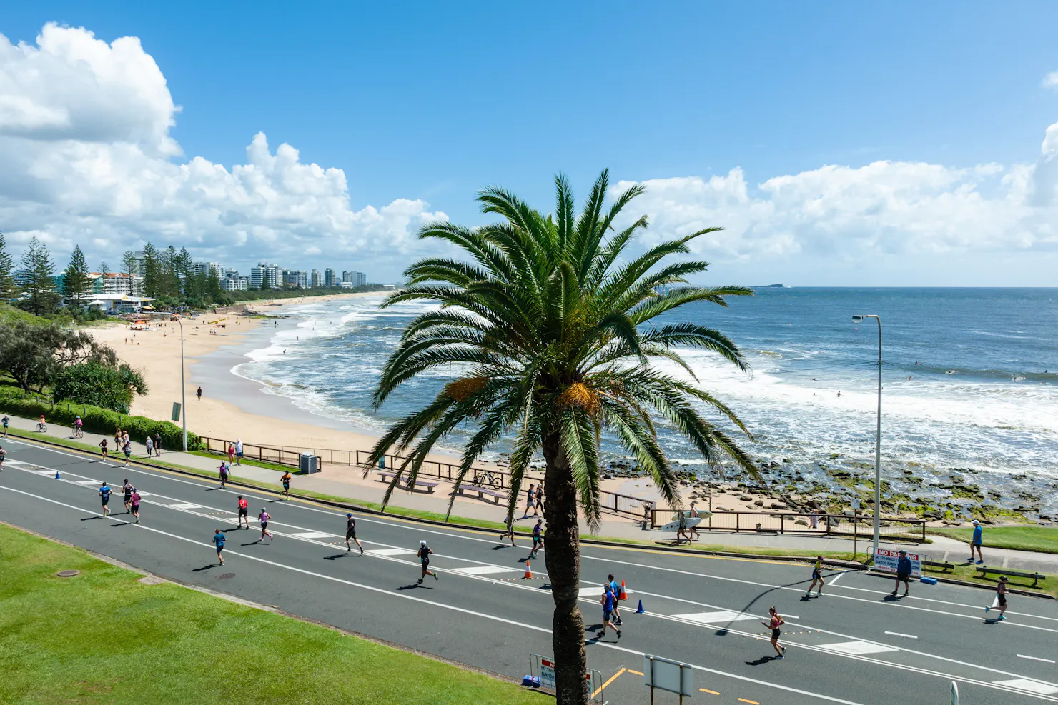 A photo of runners alongside Mooloolaba Beach