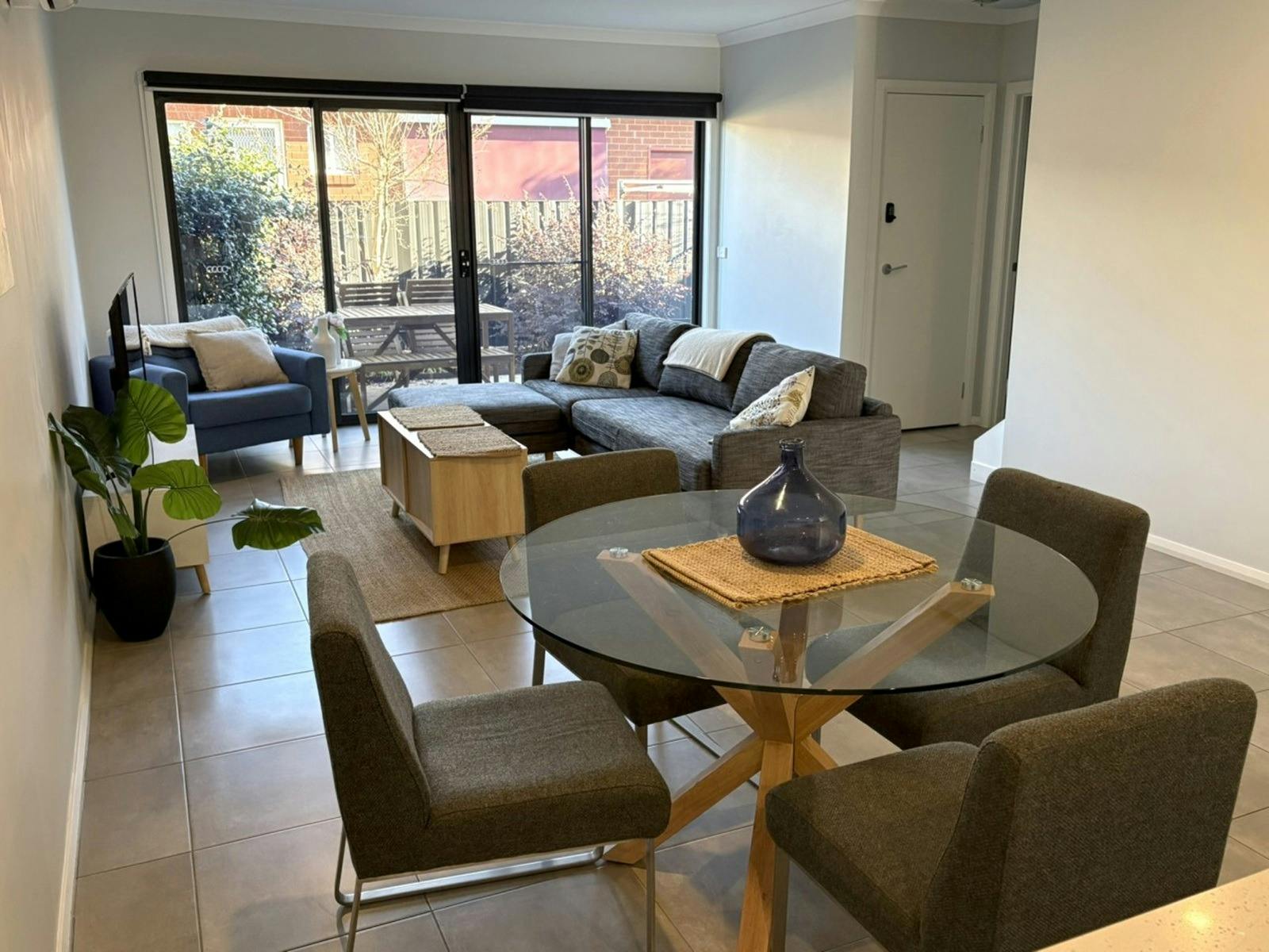 picture of a loungeroom and dining table that seats 4