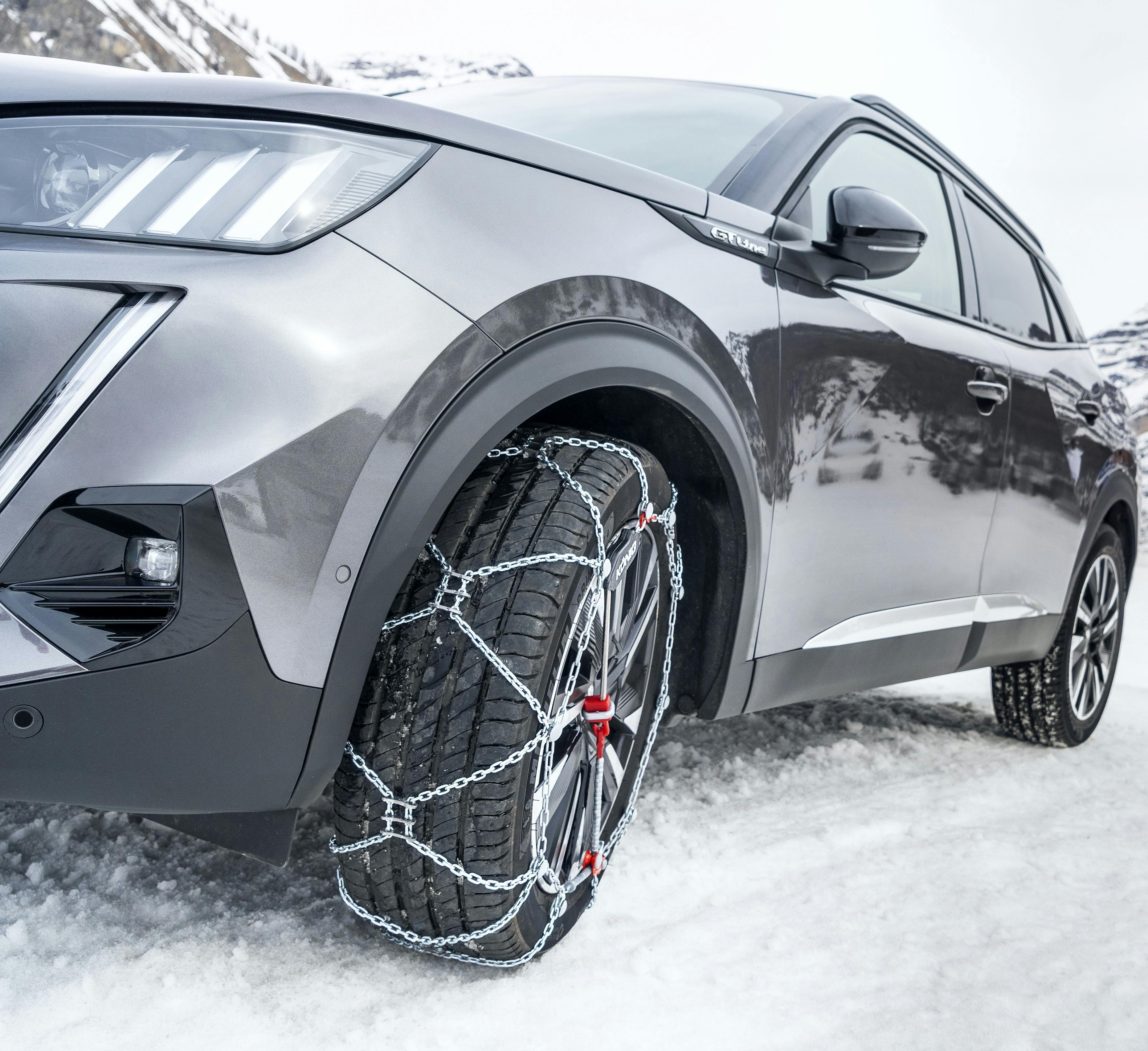 grey car with snow chains fitted to tyres