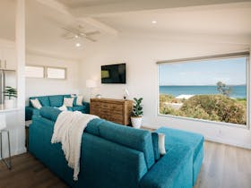 The lounge in the upstairs living room has comfortable seating for at least 6 people with a view