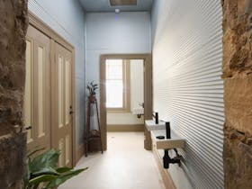 Hallway to Bathroom with iron walls and window