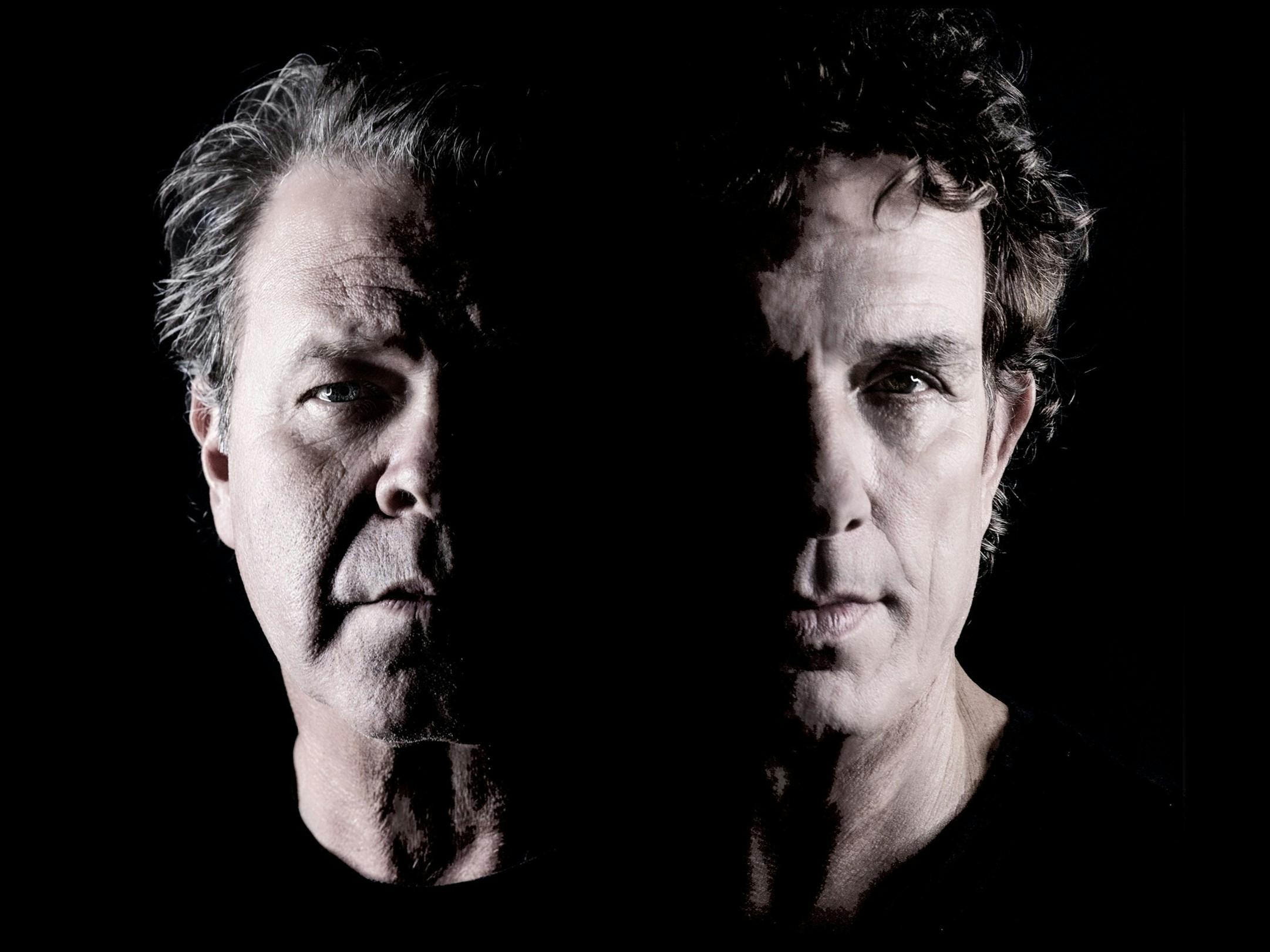 Ian Moss and Troy Cassar-Daley posing in front of black background.