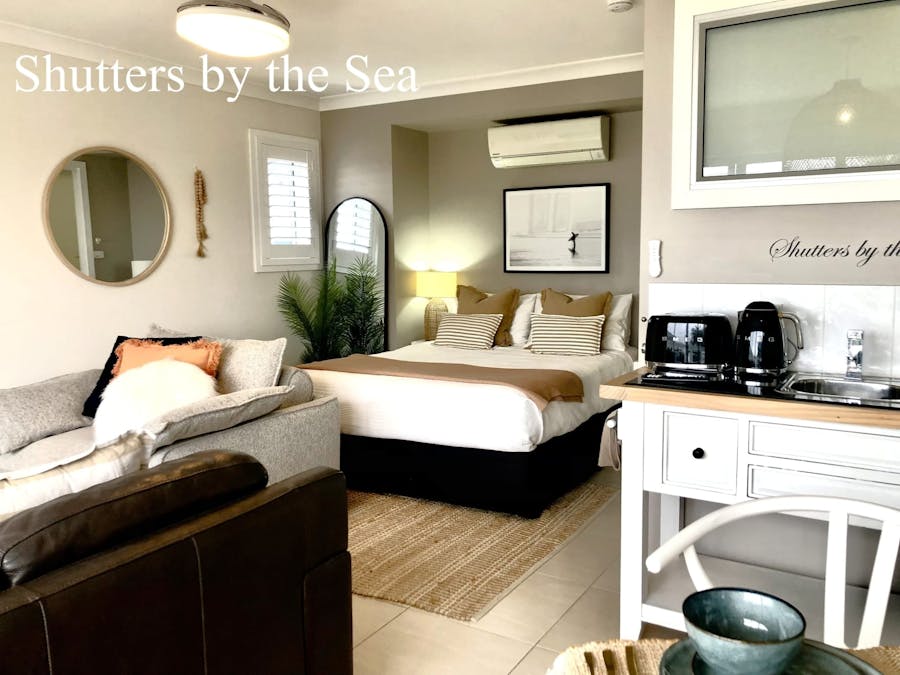 Room with queen bed , sofa and kitchenette with kettle and toaster