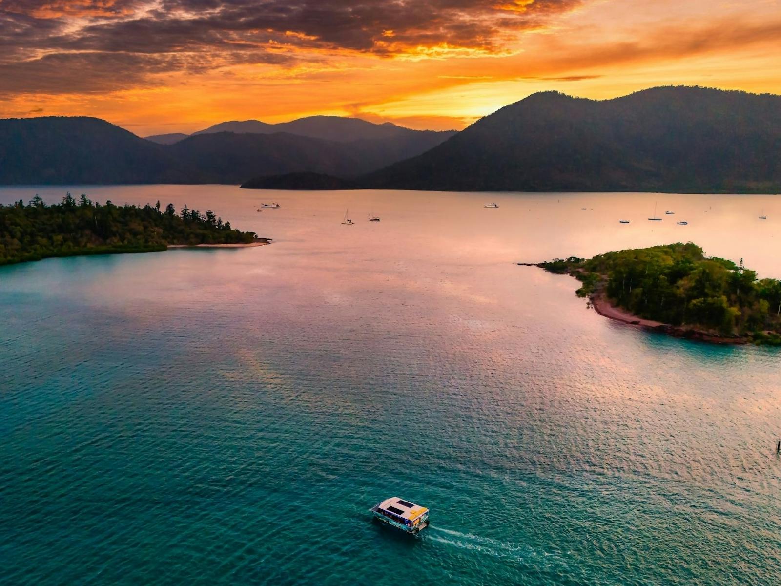 Glass Bottom Boat cruising through sunset