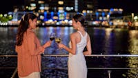 Ladies having a drink on the deck of Spirit of Cairns at nighttime