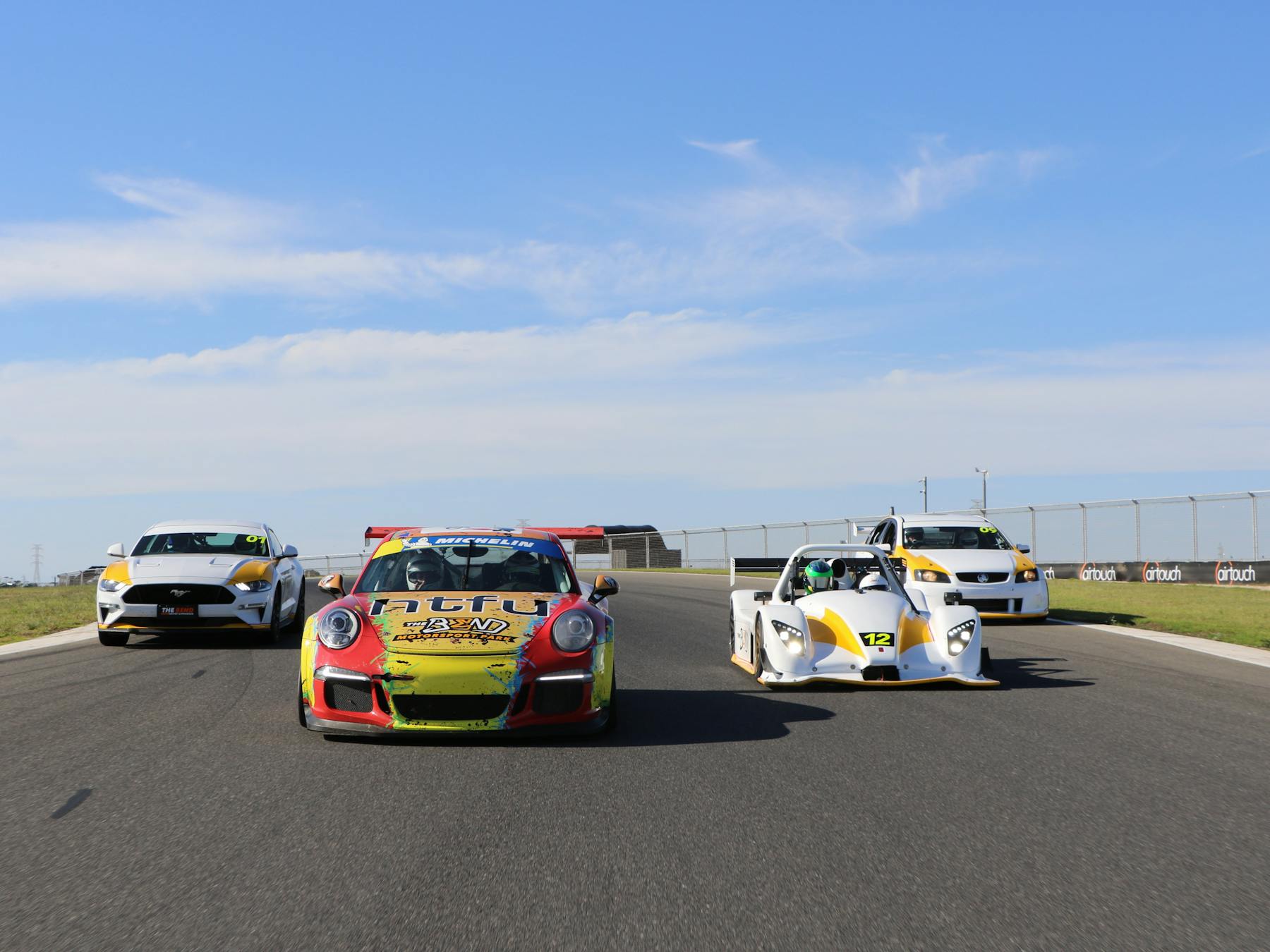 4 race cars on track