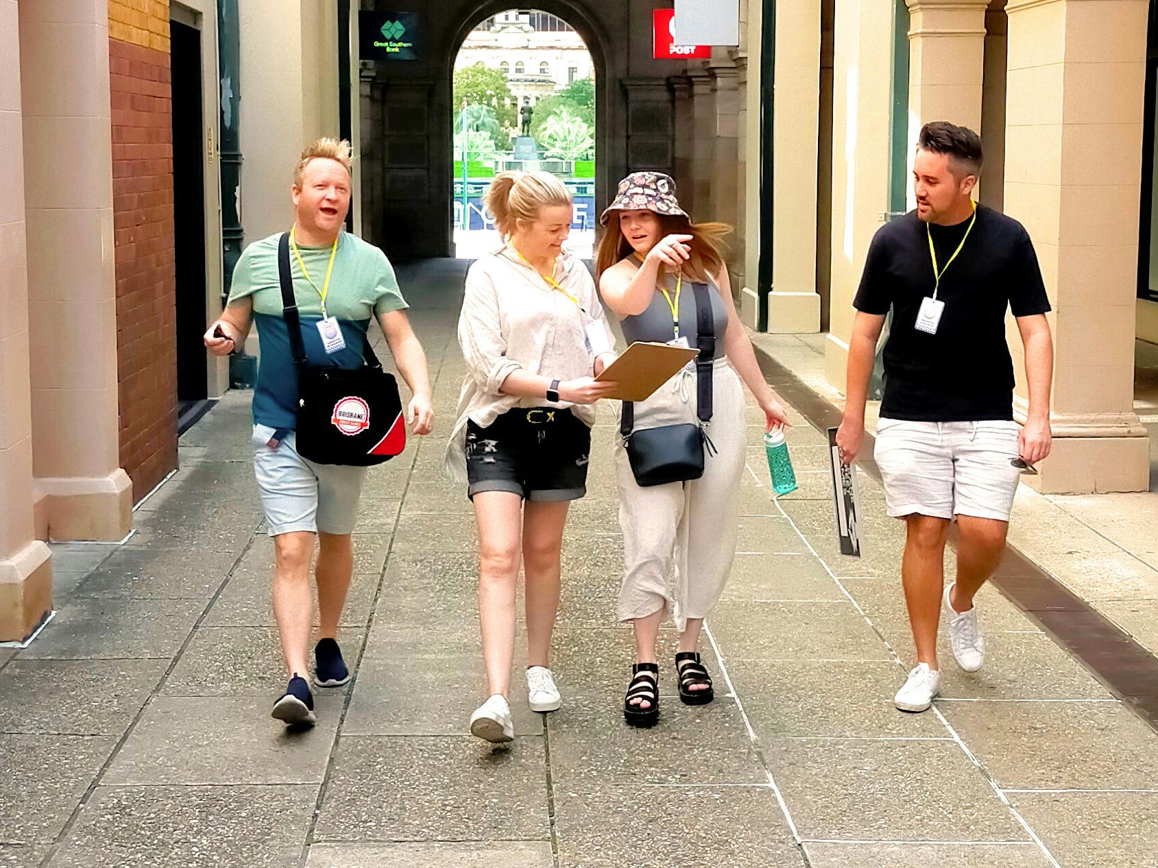 Two men and two ladies walking in an alleyway