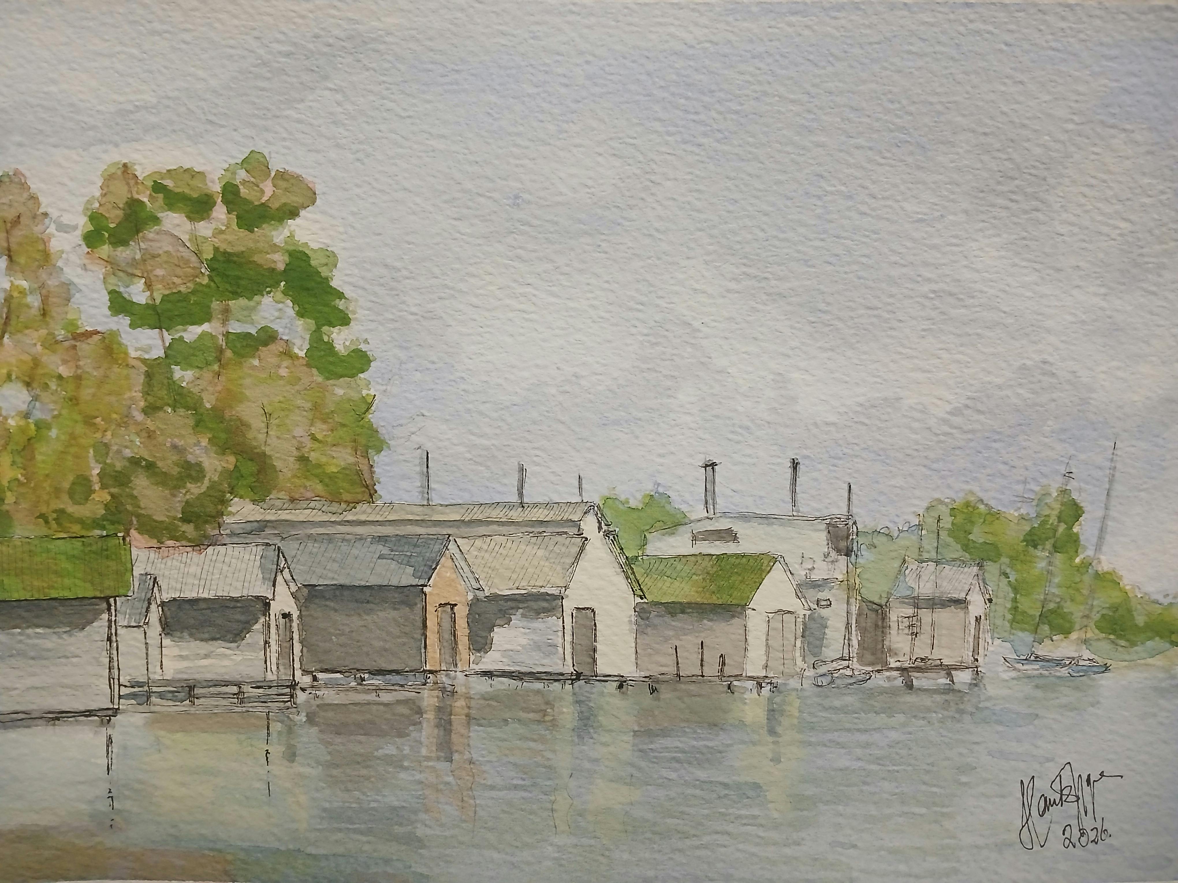 Tranquil scene of Lake Wendouree boatsheds on a calm day with reflections .