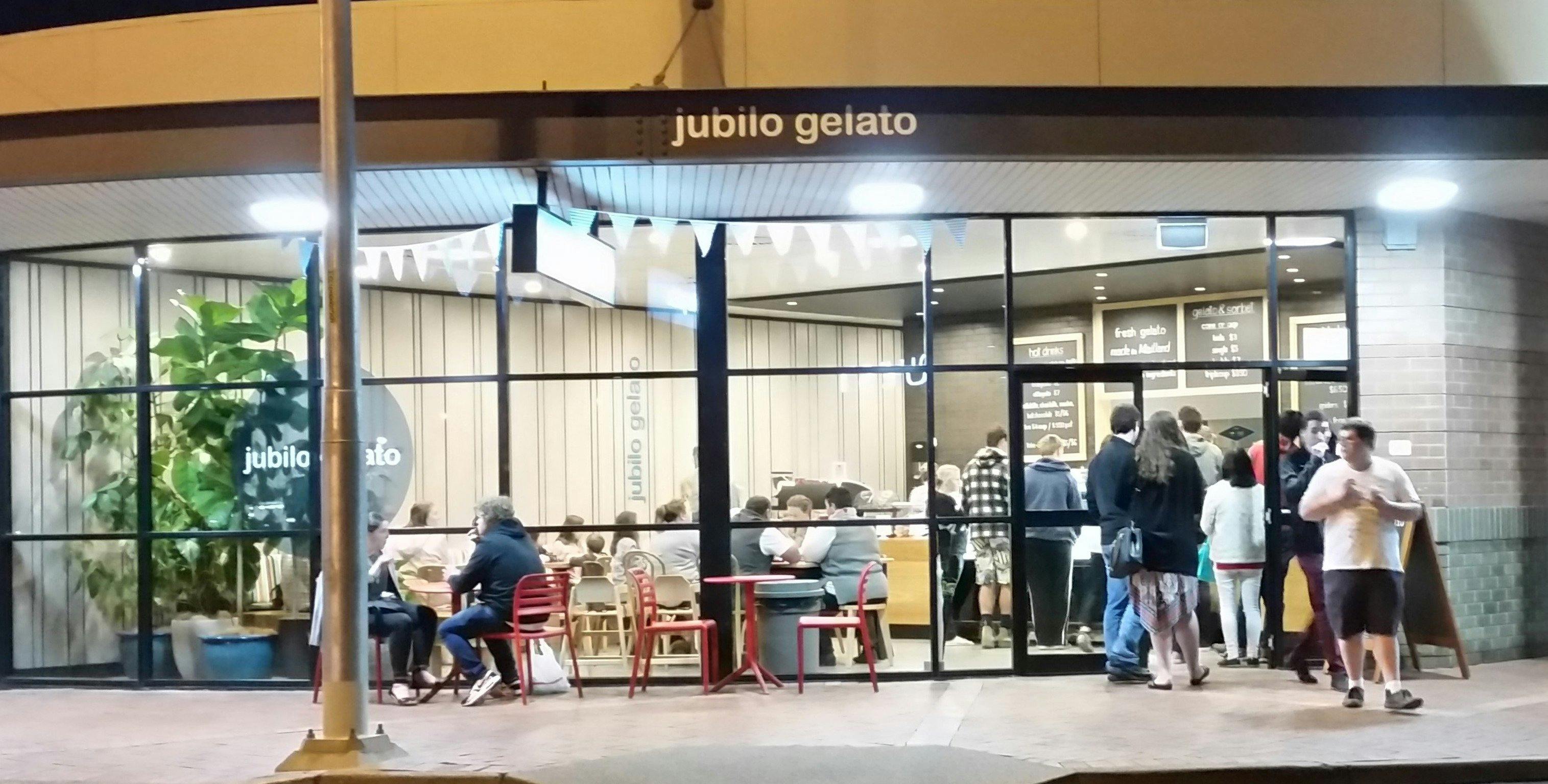 Photo of Jubilo Gelato building exterior showing night time crowds.