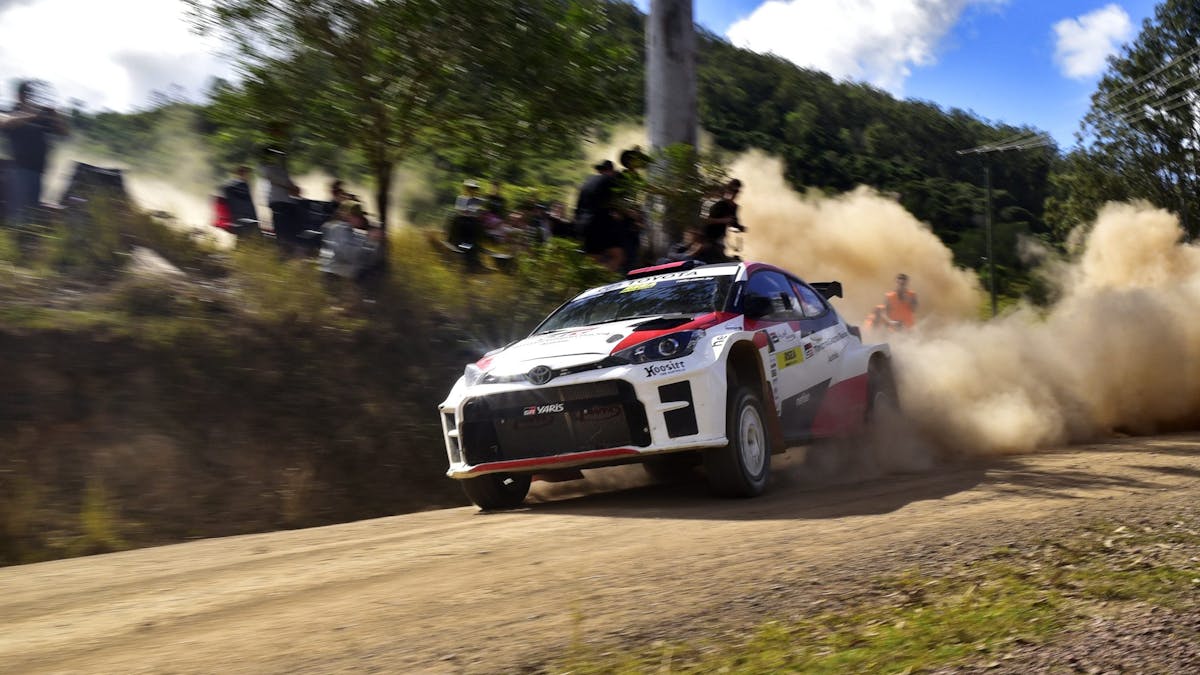 Rally car racing on gravel road