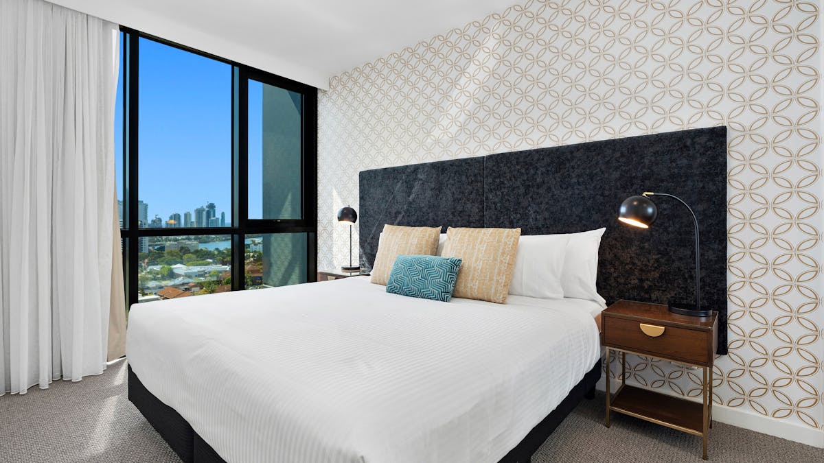 Spacious two-bedroom apartment with modern decor, private balcony, and stunning Gold Coast views.
