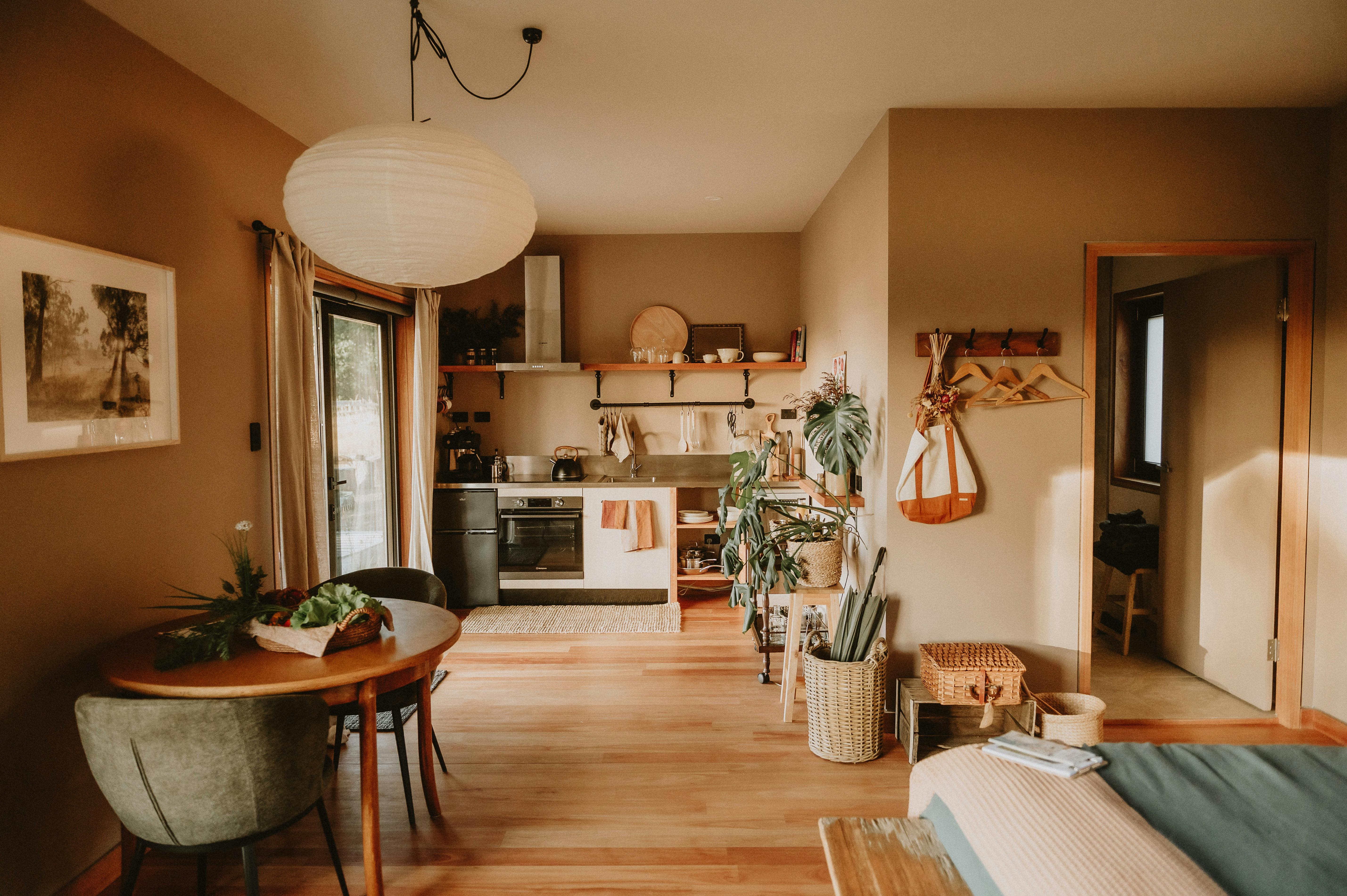 Cabin interior with table and a kitchenette in the background