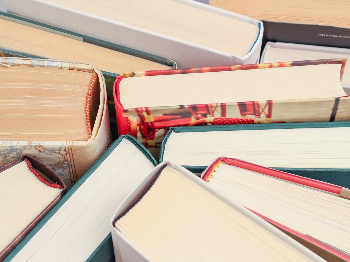 Boks standing up right on the table so you can see the bottom of each book