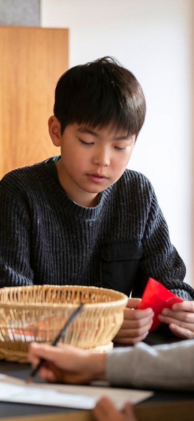 Children seated at a table doing craft activities