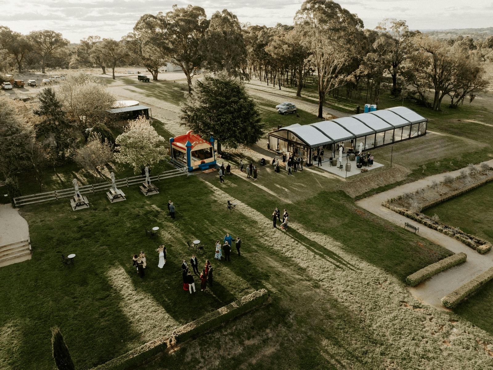 Drone photo of vineyard with marquee and green space