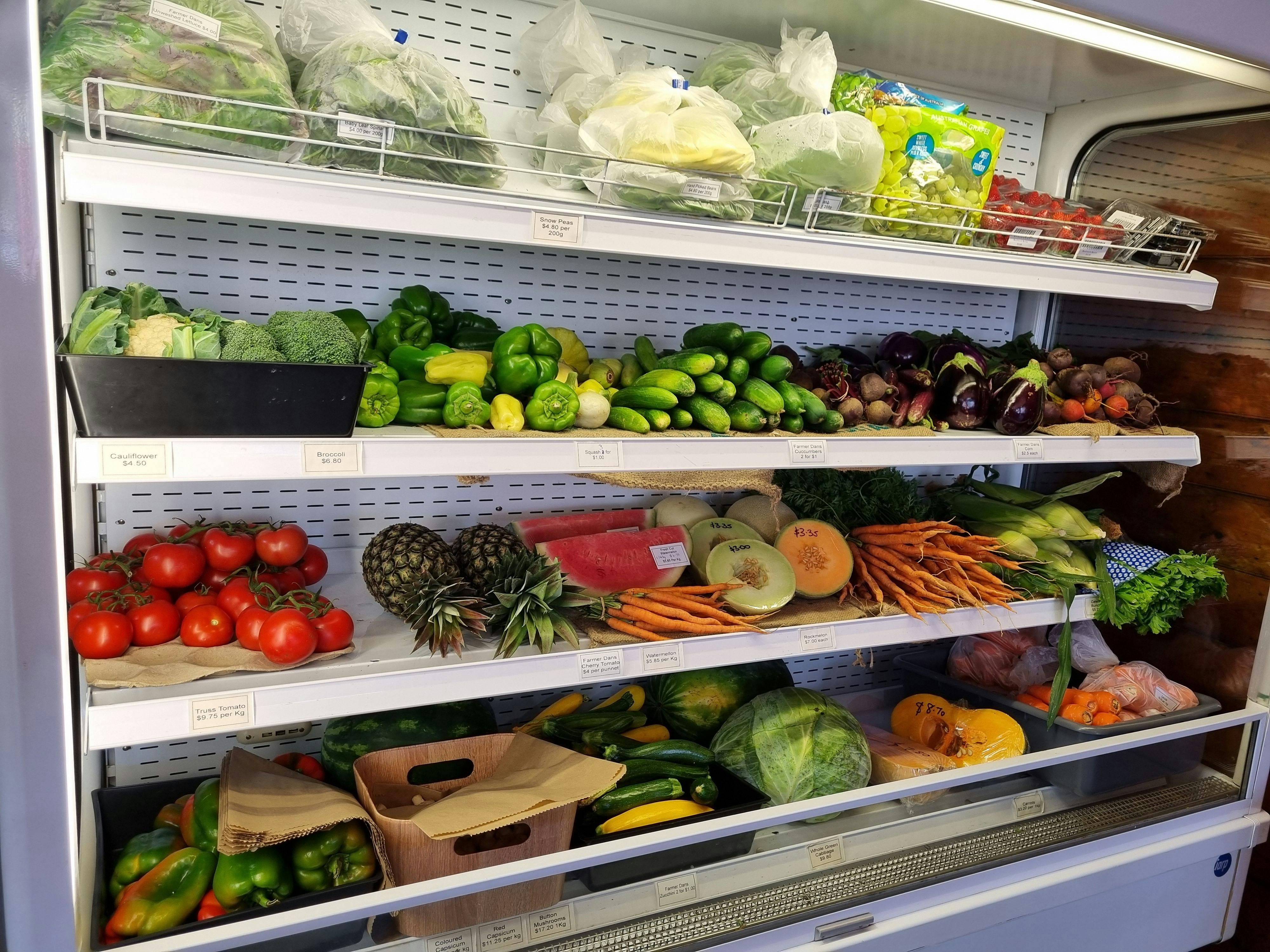 A fridge with fresh vegetables and fruit