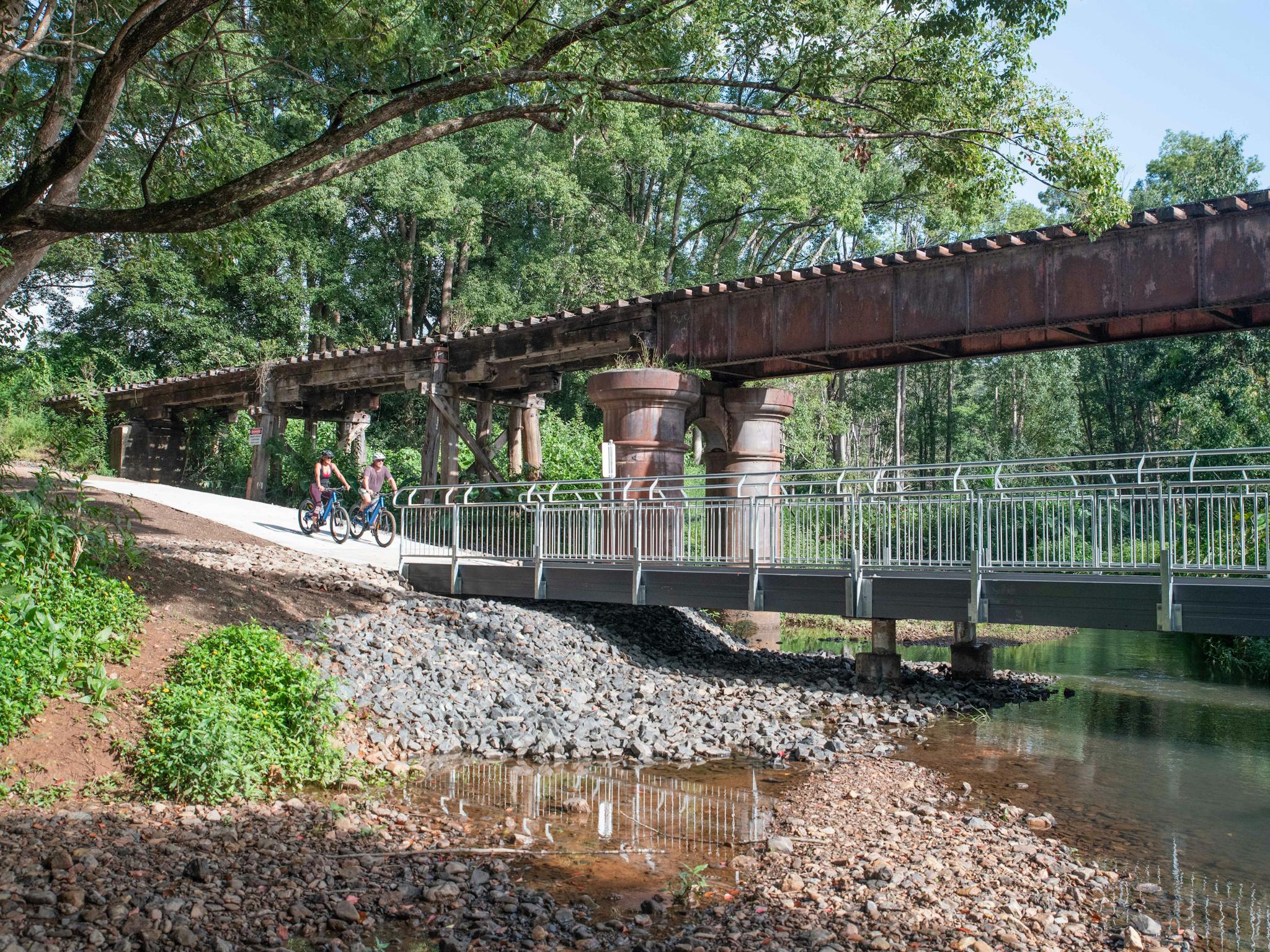 Riding past the upper Burringbar rail bridge on the Northern Rivers Rail Trail with Better By Bike