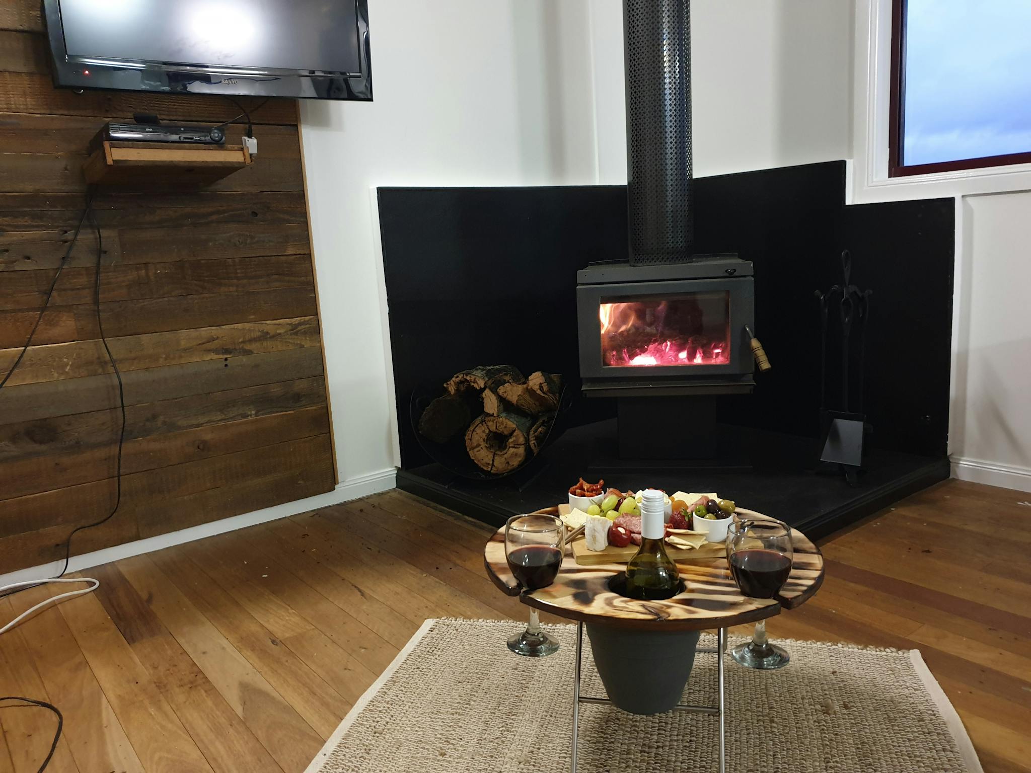 fireplace, tv and wine & cheese board