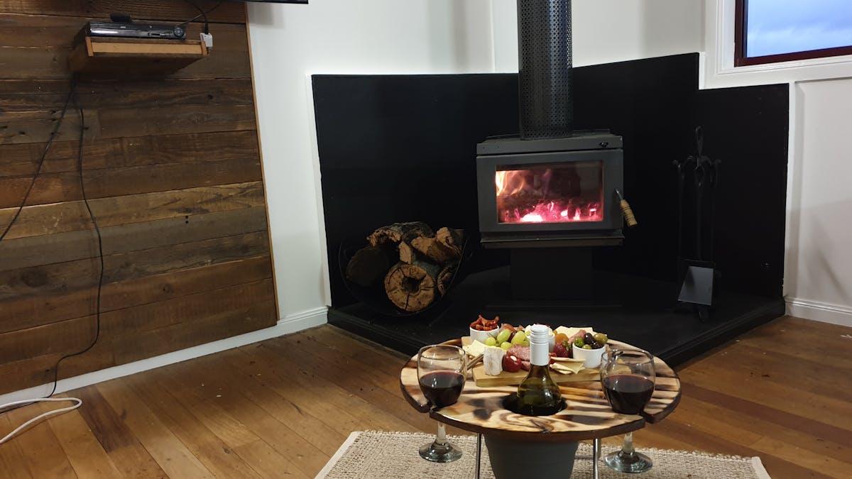 fireplace, tv and wine & cheese board