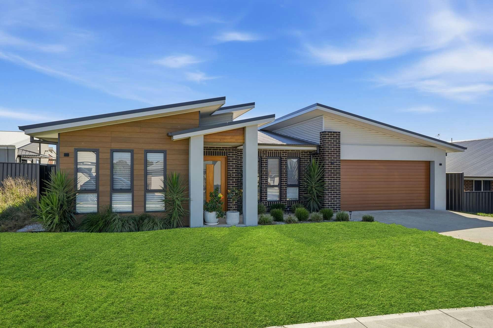 Modern home in orange with brick and rendering