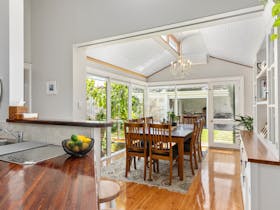A full, well equipped kitchen joins a light-filled conservatory overlooking the courtyard garden.