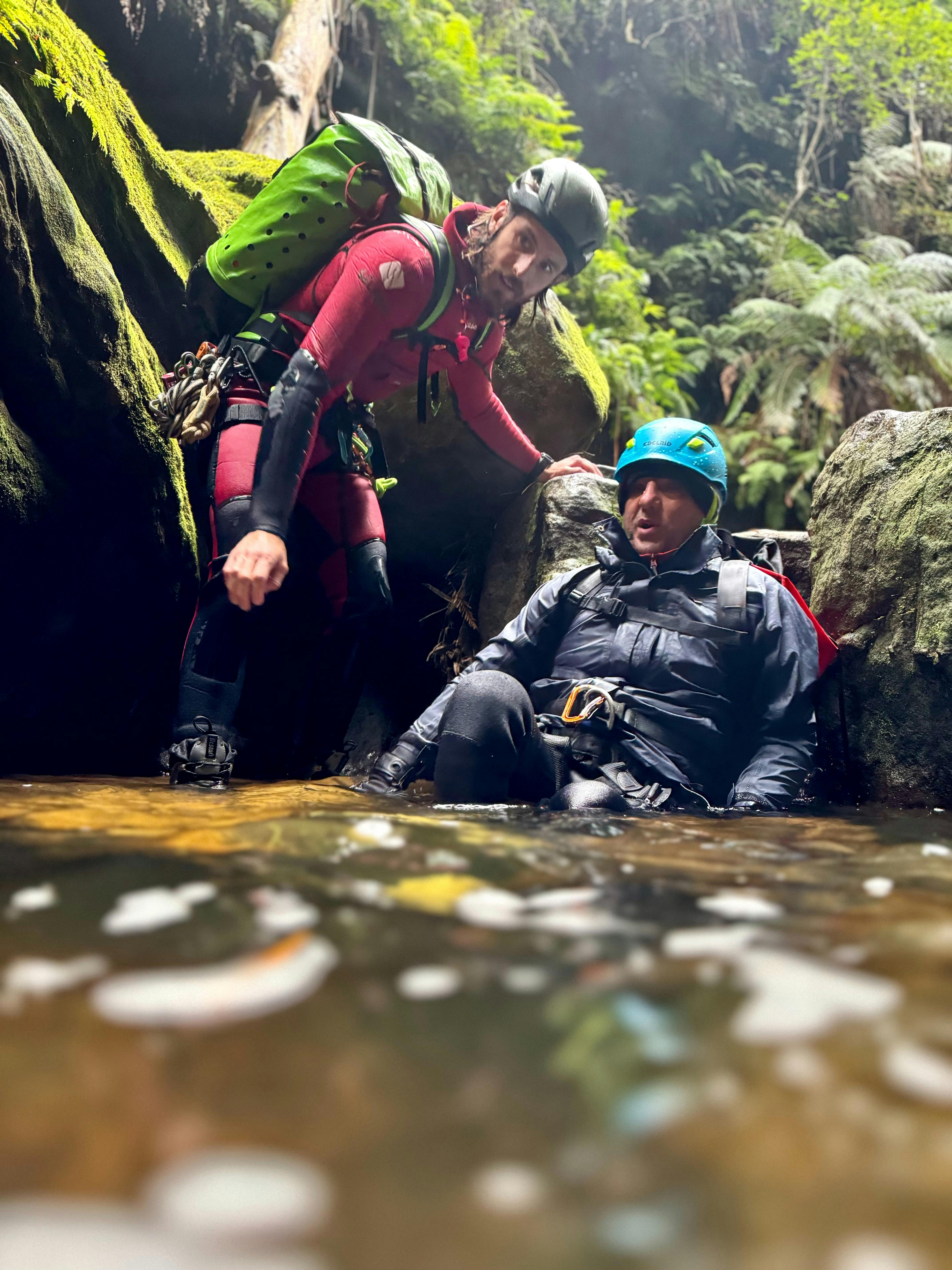 A paraplegic canyoner taking a break in a canyon on a portable chair