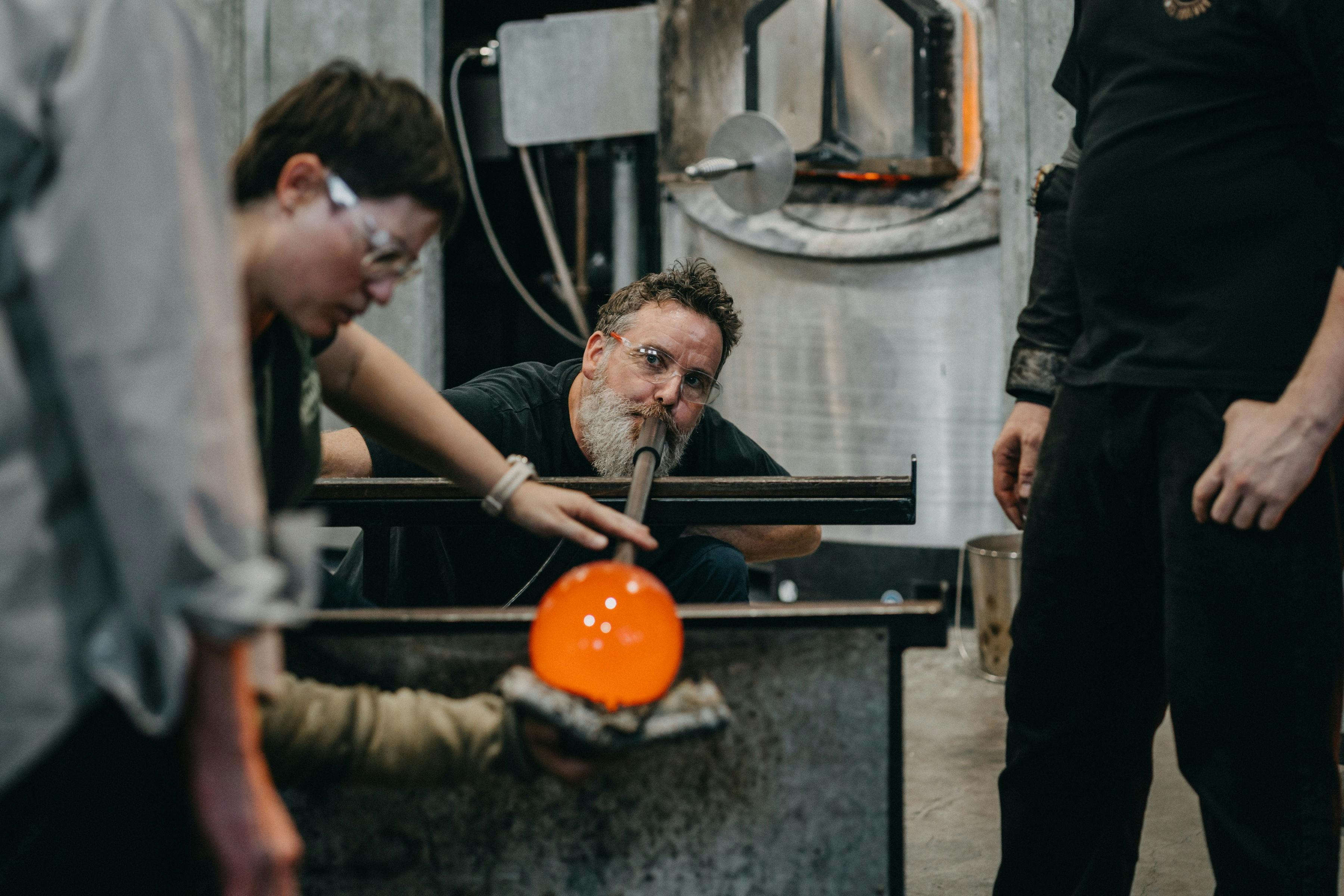 Artists glass blowing in the Hotshop
