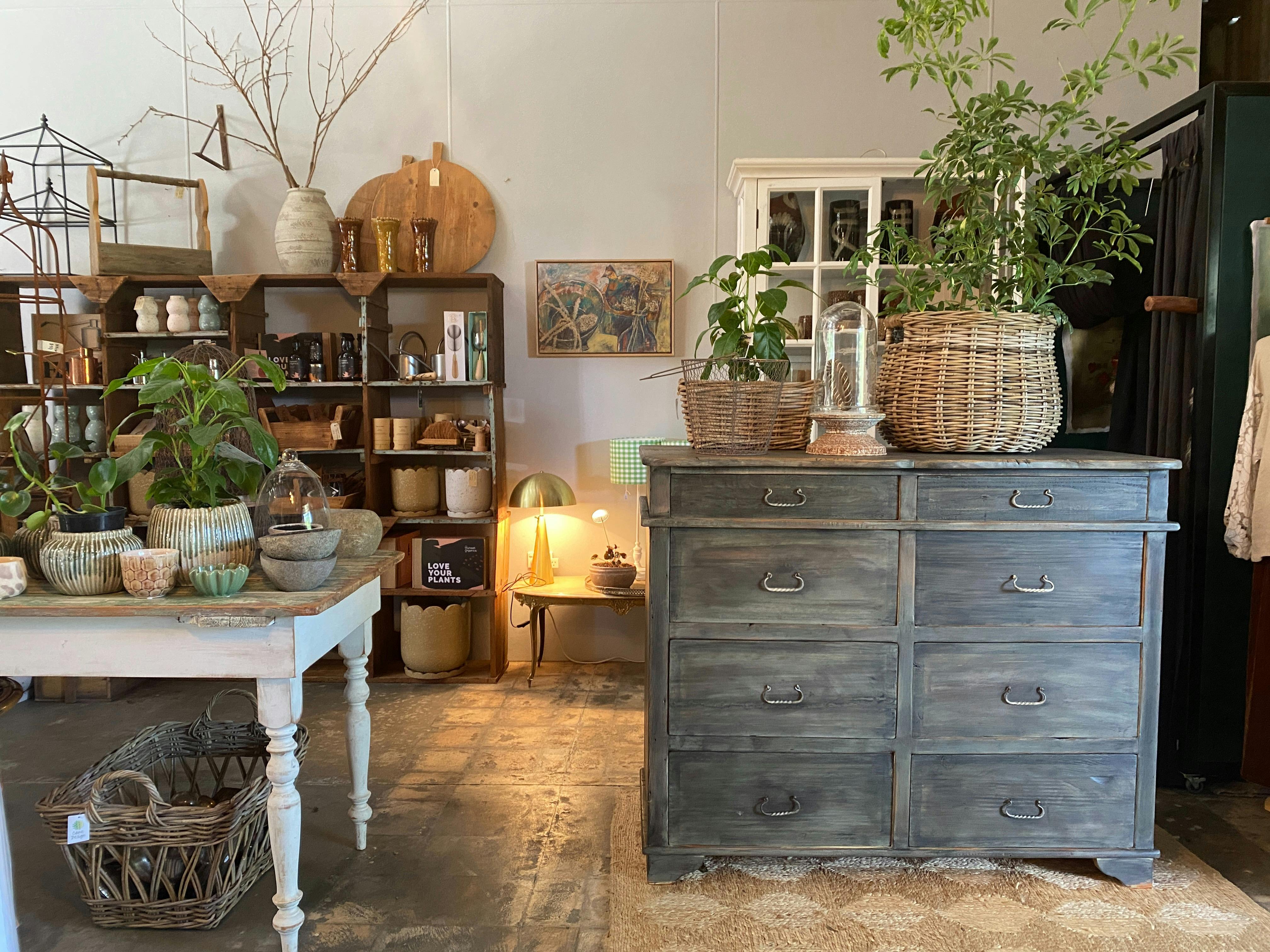 An eclectic mix of homewares sit nestled amongst one-off pieces of restored rustic vintage furniture