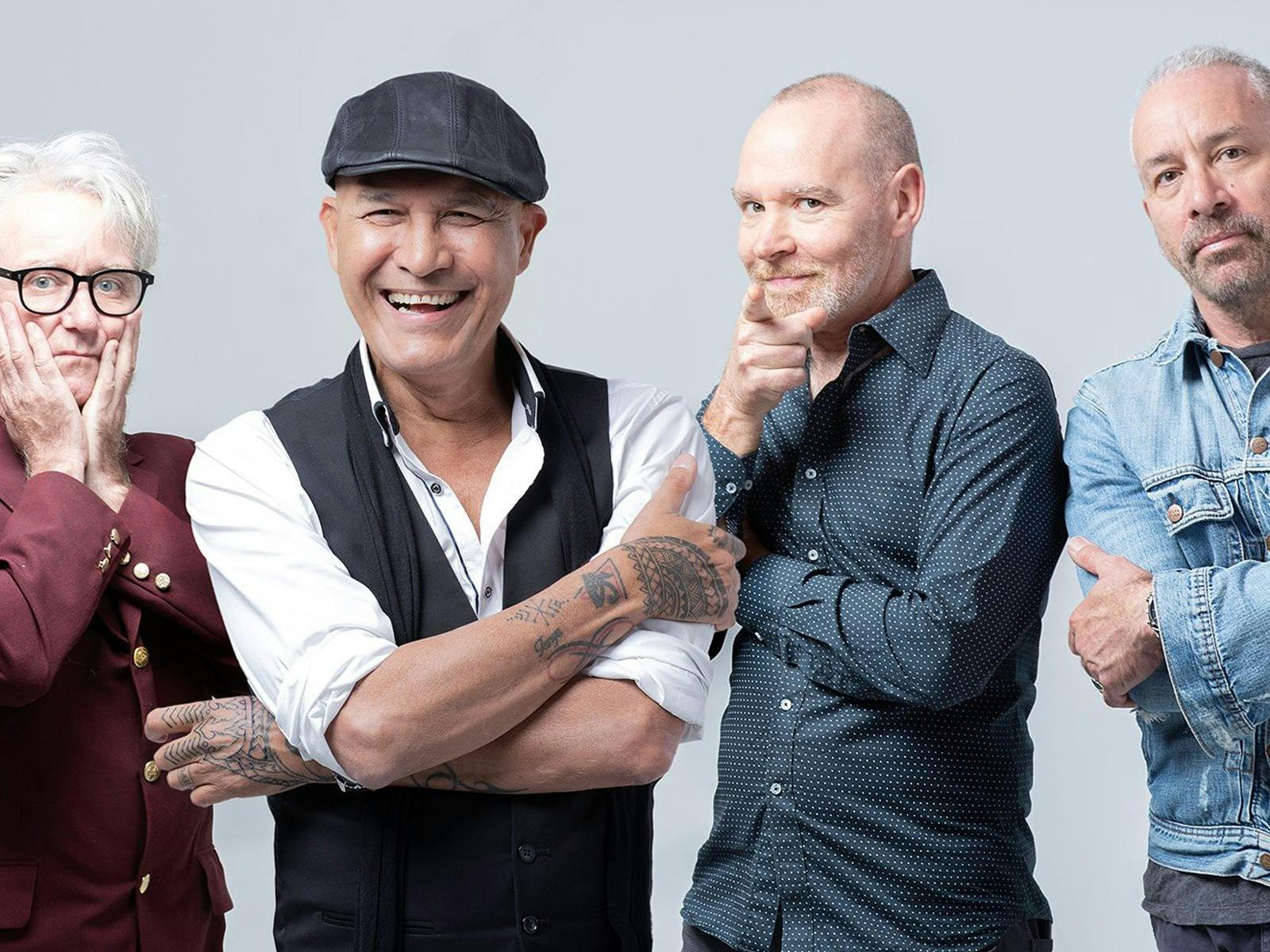a photo of 4 members of boom crash opera facing the camera