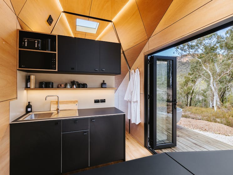 Kitchenette opens up to the great outdoors via double glazed bifold doors on both sides.