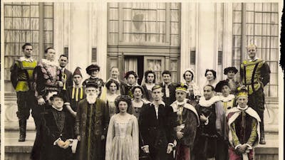 group of 20 people standing outside dressed in classical Shakespearean costume