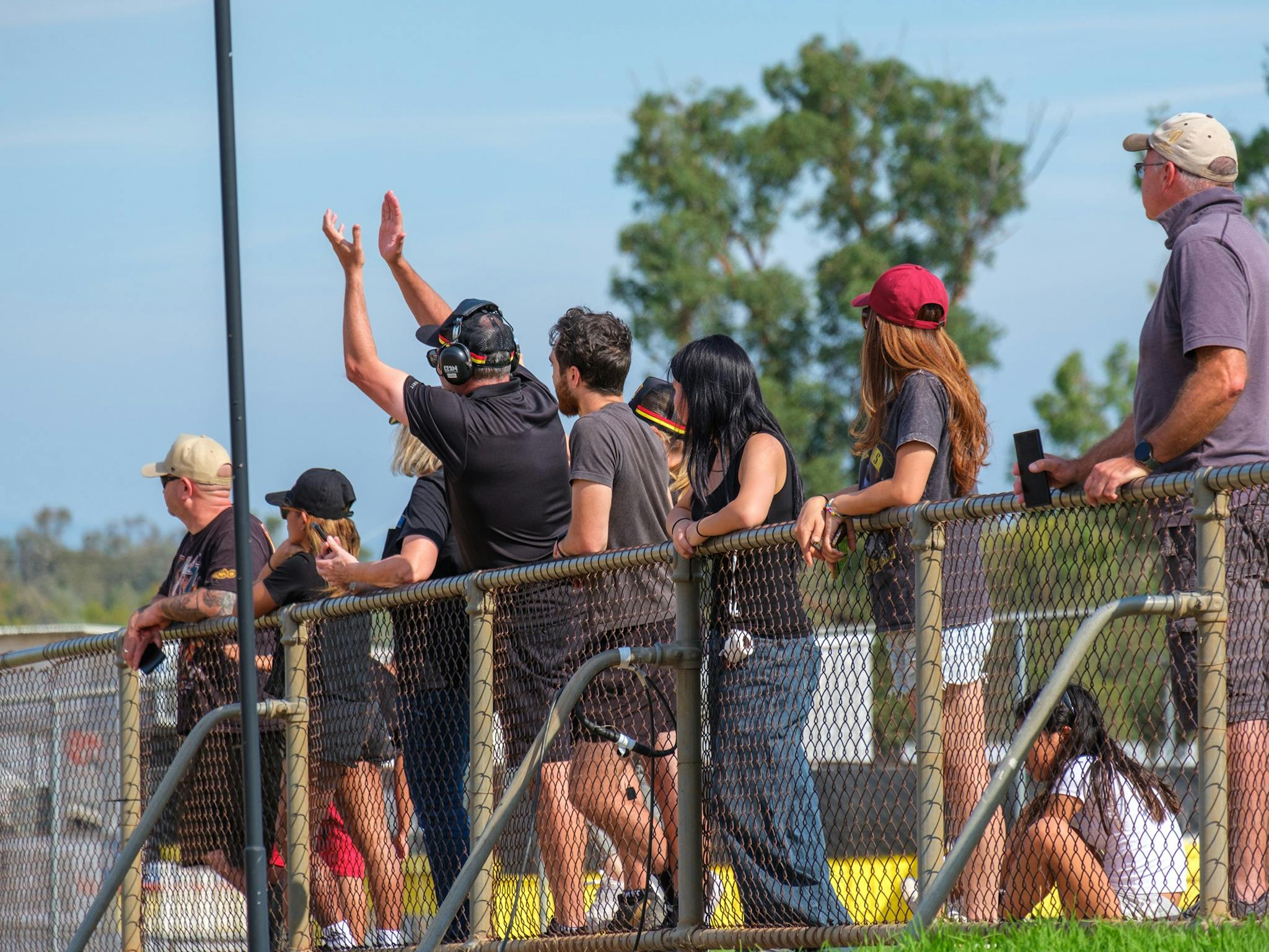 Group of people watching a race and cheering on competitors