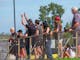 Group of people watching a race and cheering on competitors