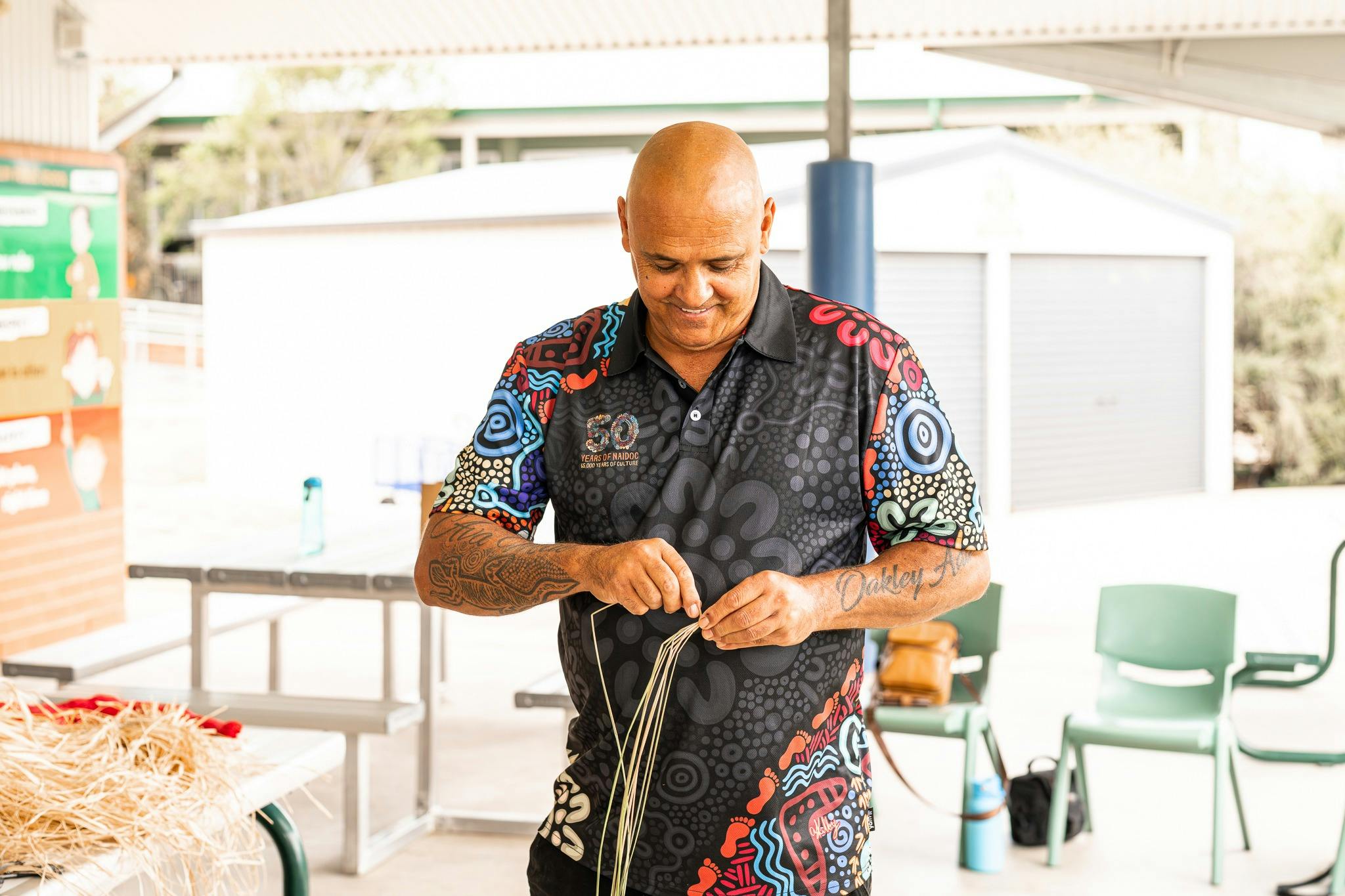 Aboriginal cultural producer and educator Shane Herrington working wtih stringy bark to make rope