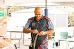 Aboriginal cultural producer and educator Shane Herrington working wtih stringy bark to make rope