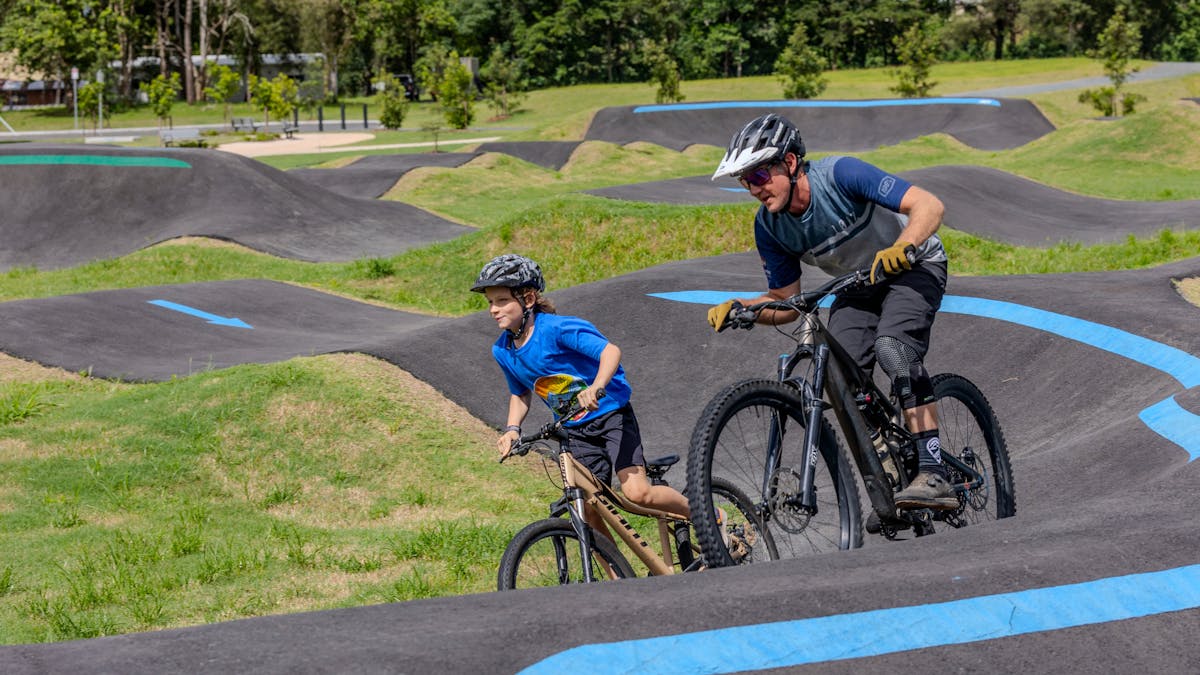 Father and sun riding the Finch Hatton MTB Pump Track