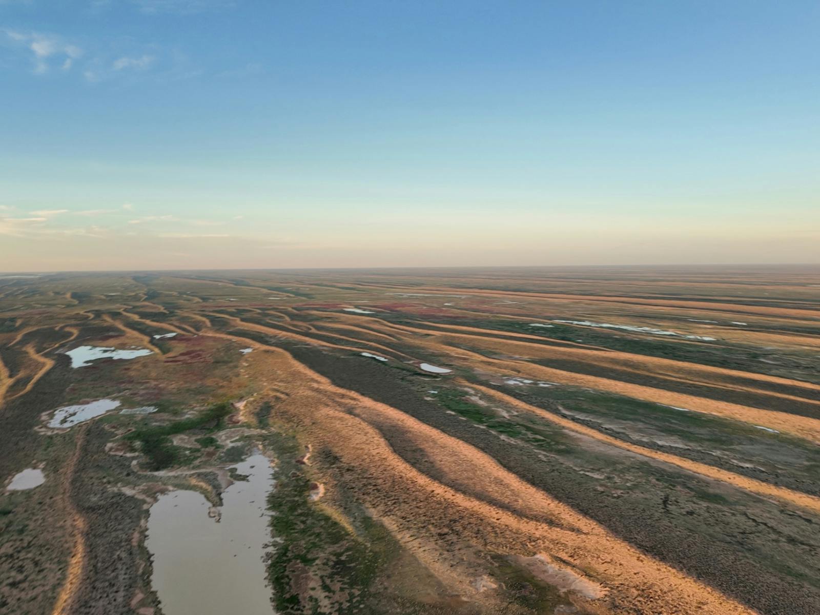 Aerial view of winding inland channels and floodplains across the arid landscape near Lake Eyre Aerial view of winding inland channels and floodplains across the arid landscape near Lake Eyre