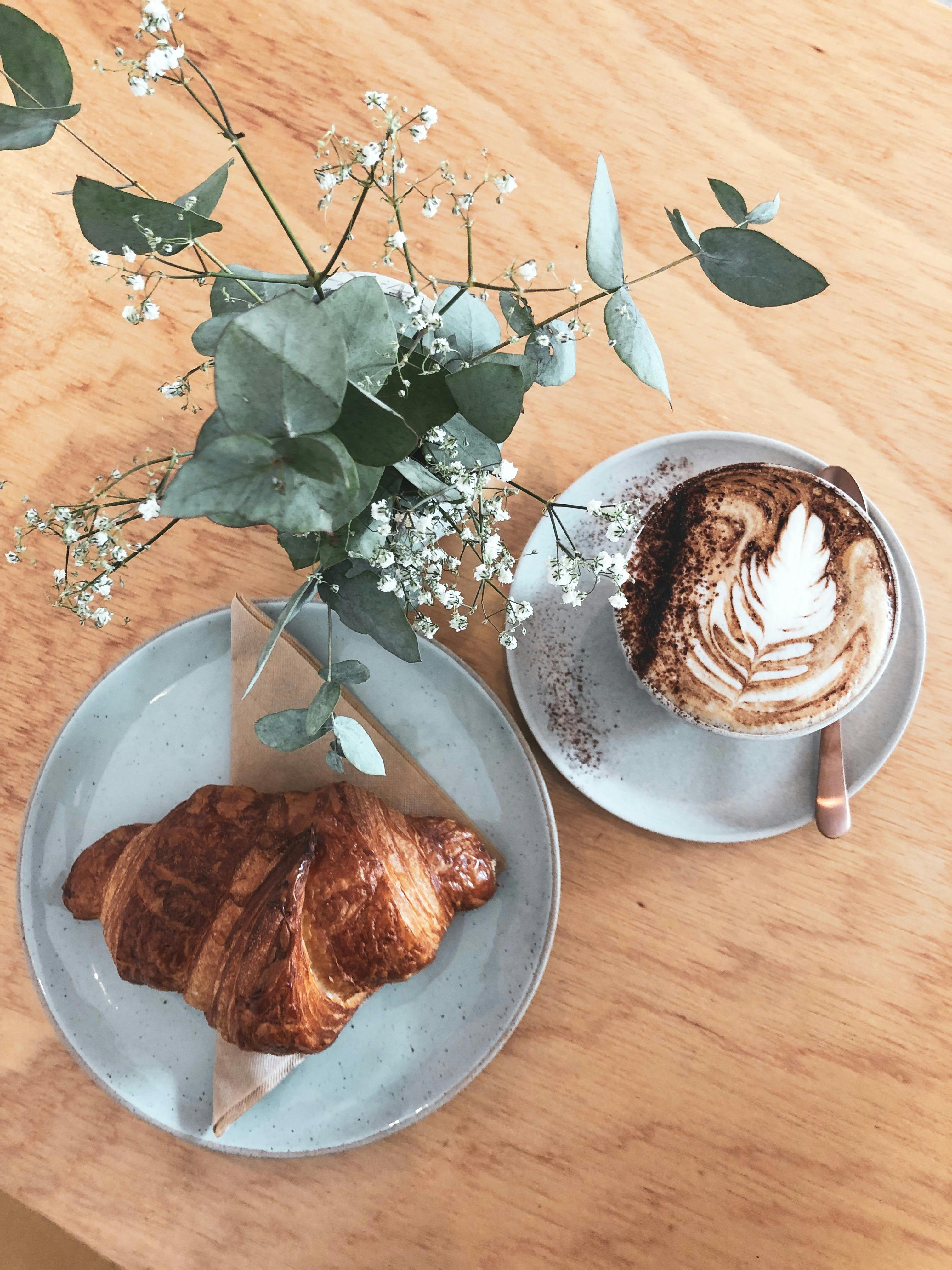Coffee in the morning sun with a freshly baked croissant